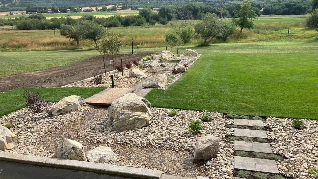 a green lawn styled with stone hardscapes