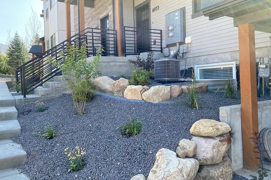 a residential landscaping using stones and grasses