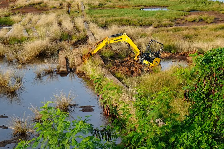 restoring a wetland with an excavator