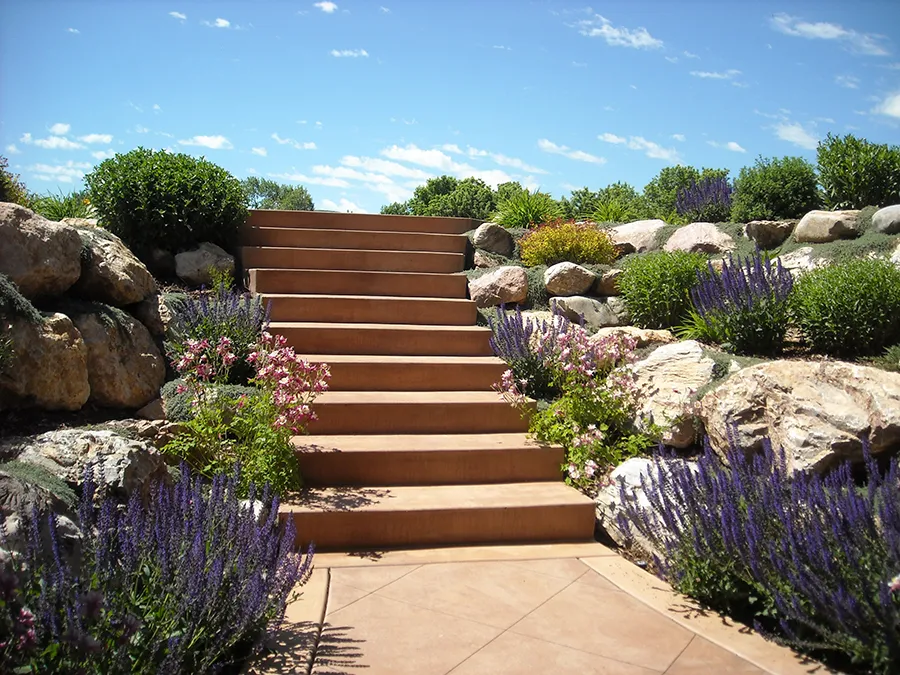 a staircase featuring natural stone hardscapes, lavender, and foliage