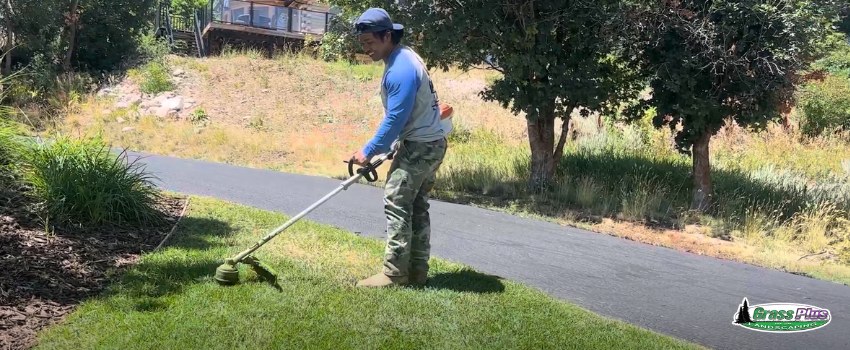 A lawn care technician mowing the grass