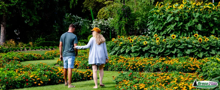 GPI - Couple walking in green, lush garden